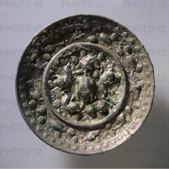 Animal-and-Grape Mirror, early 7th Century - early 10th Century. China, Tang dynasty (618-907). Bronze; diameter: 13.7 cm (5 3/8 in.); overall: 1.4 cm (9/16 in.); rim: 1.4 cm (9/16 in.).