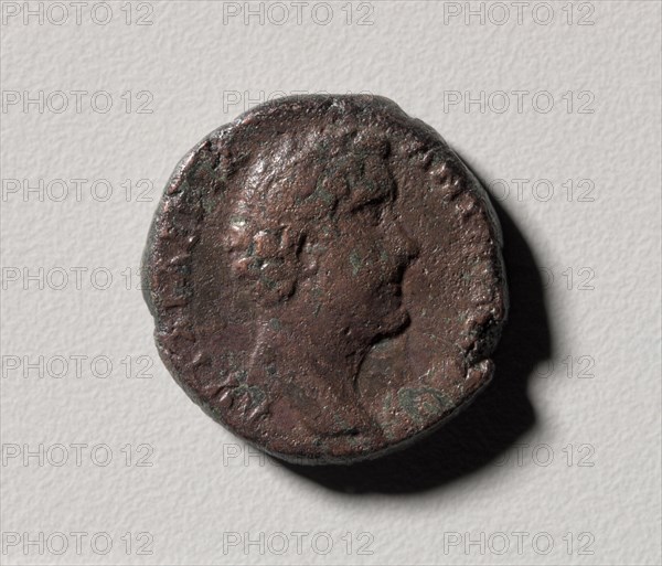 Profile Head of Antoninus Pius of Nicopolis (Nikopolis) ad Istrum (obverse) Apollo Sauroktonos (reverse), 138-161. Moesia Inferior, near modern Veliko Tarnovo Bulgaria, 2nd century. Bronze; diameter: 2.5 cm (1 in.).