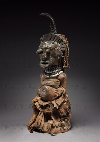 Male Figure, late 1800s-early 1900s. Central Africa, Democratic Republic of the Congo, Songye people. Wood, glass beads, brass, copper, iron, human teeth, antelope horn, hide, animal hair, minerals, plant fibers; overall: 64 x 24.5 x 24 cm (25 3/16 x 9 5/8 x 9 7/16 in.)