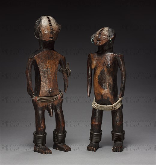 Pair of Figures, late 1800s-early 1900s. Central Africa, Democratic Republic of the Congo, probably Ngbandi people. Wood, copper, glass beads, iron, fabric; part 1: 45 x 15.5 x 9.2 cm (17 11/16 x 6 1/8 x 3 5/8 in.); part 2: 41 x 13 x 11.5 cm (16 1/8 x 5 1/8 x 4 1/2 in.)