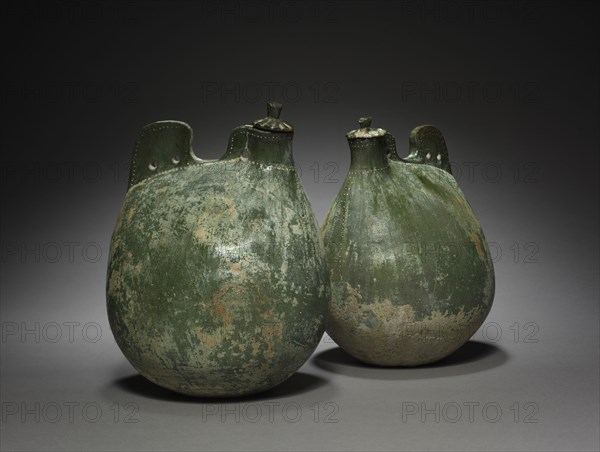 Pair of Leather Bag-Shaped Flasks with Covers, 916-1125. Northeast China, Liao dynasty (916-1125). Earthenware with green glaze; part 1: 24.5 x 16.5 x 16 cm (9 5/8 x 6 1/2 x 6 5/16 in.); part 2: 23.5 x 17.5 x 13.8 cm (9 1/4 x 6 7/8 x 5 7/16 in.).