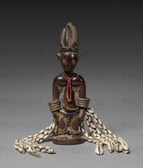 Memorial Figure (Ere ibeji), late 1800s-early 1900s. Guinea Coast, Nigeria, Yoruba people. Wood, metal, beads, cowries, fiber, blue pigment; overall: 25.6 x 18.8 x 5.8 cm (10 1/16 x 7 3/8 x 2 5/16 in.)