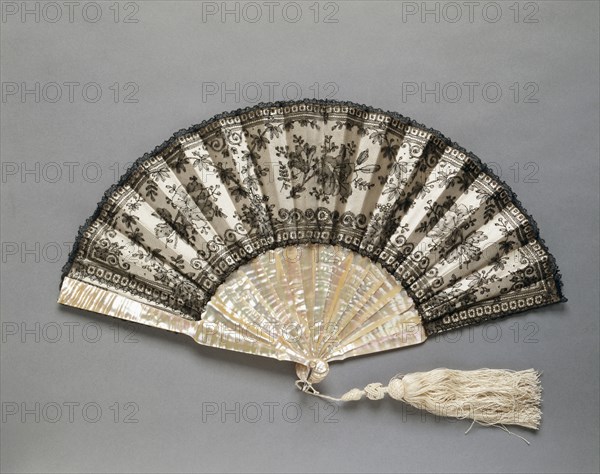 Folding Fan: Chantilly Lace, c. 1870. France (probably), 19th century. Black "Chantilly" lace over silk lining, white silk tassel; frame: mother-of-pearl; radius: 27 cm (10 5/8 in.); spread: 49.5 cm (19 1/2 in.).