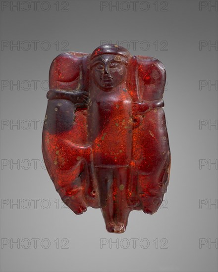 Pendant: Divinity Holding Hares; Italy; 600 - 550 B.C; Amber; 97 × 64 × 24 mm, 3 13,16 × 2 1,2 × 15,16 in