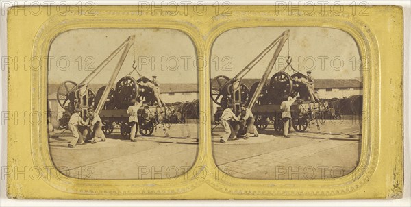 Men loading large iron wheels on platform; about 1865; Hand-colored Albumen silver print