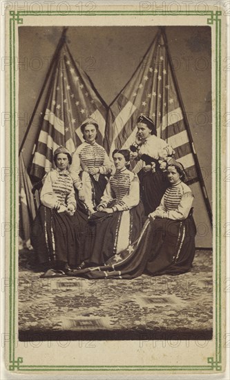 Five women, two standing, three seated, in costume, posed in front of two American flags; American; about 1865; Albumen silver