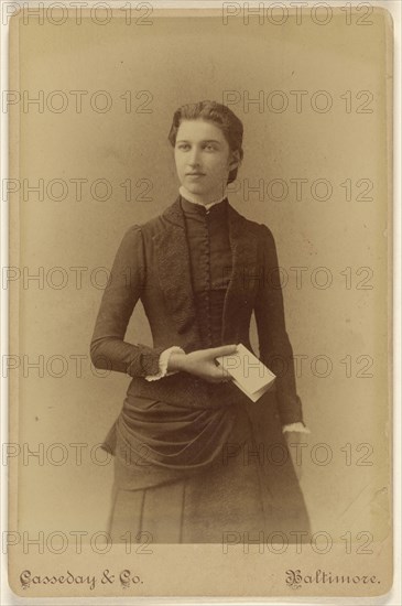 young woman holding a piece of folded paper, standing; Casseday & Company; 1880s; Albumen silver print