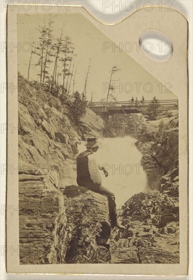 man sitting on rocks near a waterfall; about 1870; Albumen silver print