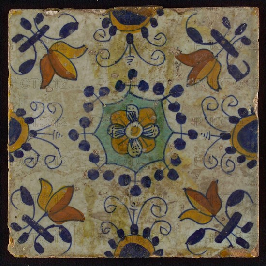 Tile, blue draft, yellow, green and orange on white, central flower within star shape, three-spot around, half rosette, corner