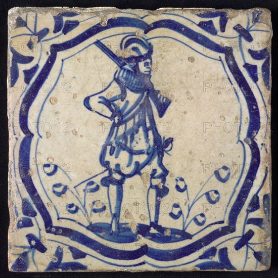 White tile with blue warrior in accolade-shaped frame; corner motif wing leaf, wall tile tile sculpture ceramic earthenware