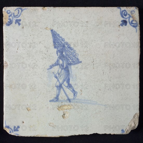 Occupation tile, blue with man with rack of firewood On the back, corner motif oxen head, wall tile tile sculpture ceramic