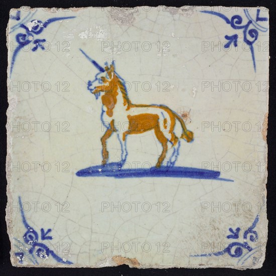 Animal tile, unicorn left in blue and brown on white, corner motif ox's head, wall tile tile sculpture ceramic earthenware glaze