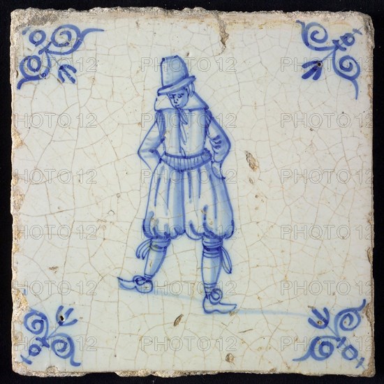 Figure tile, blue with standing man with breeches, corner pattern ox's head, wall tile tile sculpture ceramic earthenware glaze