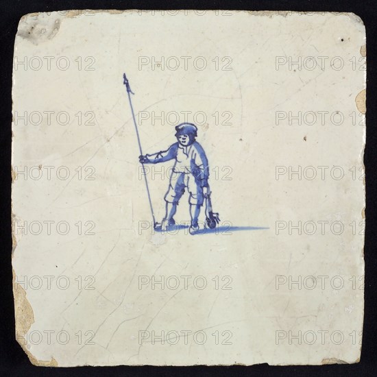 Figure tile, blue with shepherd with staff and dead rabbit in hand, no corner motif, wall tile tile sculpture ceramic