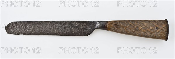 Knife with fairly wide blade and tapered handle with two legs, knife cutlery soil find leg iron? metal, archeology