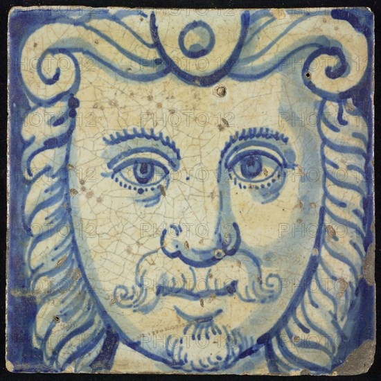 Tile of chimney pilaster, blue on white, head of man with long curly hair, curly mustache and beard, chimney pilaster tile