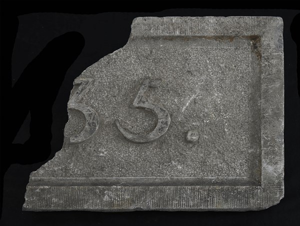 Fragment of facing brick with text ..35, facing brick building part stone, minced meat Rectangular frame and year in high relief