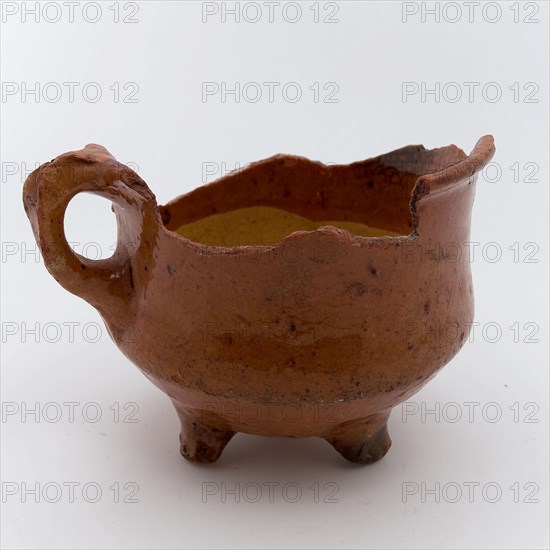 Fragment earthenware cooking jug, completely lacquered in yellow and brown, on three legs, cooking jug