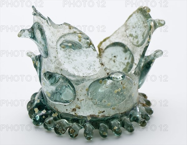 Fragment of soil, base and part of chalice birch in clear light green glass, beaker drinking glass drinking utensils tableware