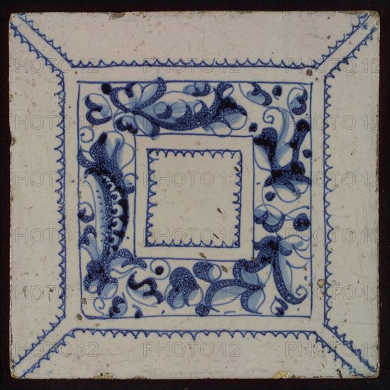 Tile, blue draft on white ground, central decor with square frame in which foglie ornament, zigzag lines, wall tile