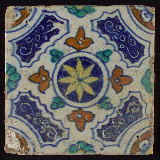 Tile, blue, green, brown and yellow on white, central yellow star in circle, sgraffito surfaces, corner motif, quarter rosette