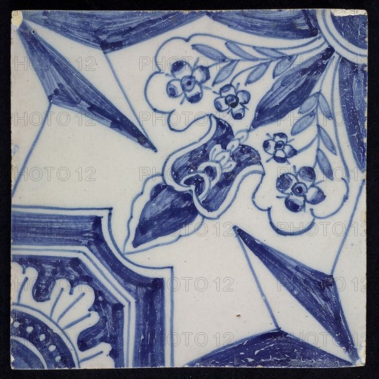 Blue ornament tile, diagonal decor with wide openwork stylized floral motif in one corner with opposite octagonal figure