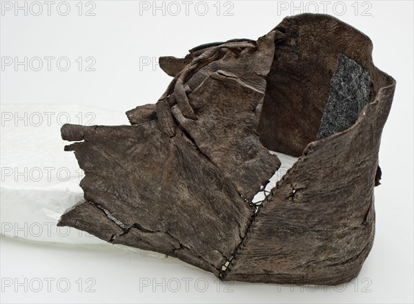 Fragment leather shoe with double leather lacing over the instep, shoe footwear clothing soil find leather, tanned cut sewn