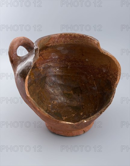 Fragment of pottery storage pot on stand, lying sausage ear, storage jar pot holder soil find ceramic earthenware glaze lead