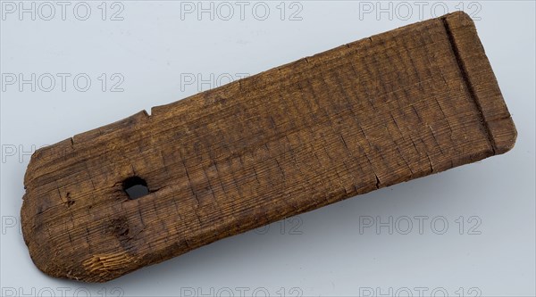 Wooden clapplate of tub with round hole for handle or rope, tons of stony foundations timber, archeology Rotterdam City center