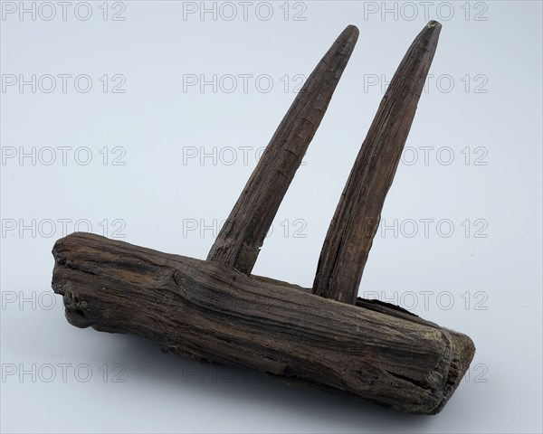 Fragment wooden rake with two teeth, rake tool equipment soil find timber, sawn drilled cut cut Fragment of wooden rake. Head