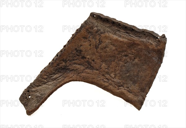 Side piece of leather shoe with sewing holes along edges, shoe footwear clothing fragment soil finding leather, archeology