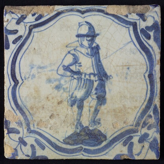 White tile with blue warrior in accolade-shaped frame, corner motif wing leaf, wall tile tile sculpture ceramic earthenware