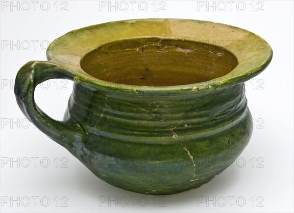 Green chamber pot with curved bottom, standing ear and wide flat edge, yellow and green glaze, pot holder sanitary soil found