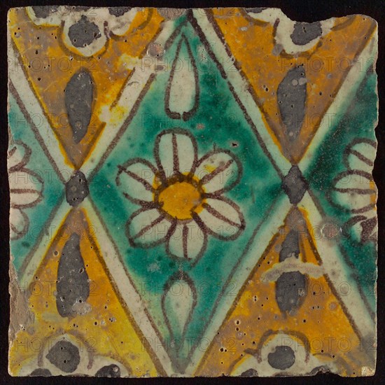 Floor tile, brown draft, green and yellow on white ground, central green oblique glass in which white flower with yellow heart