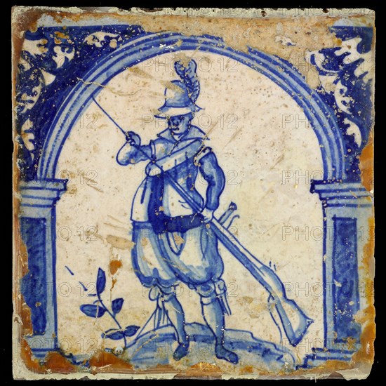 Figure tile, in blue on white, warrior with rifle, wall tile tile sculpture ceramics pottery glaze, baked 2x glazed painted