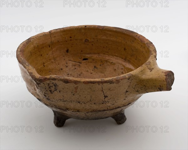 Pottery saucepan, red shard with lead glaze, short handle and pouring lip, on three legs, saucepan pan crockery holder