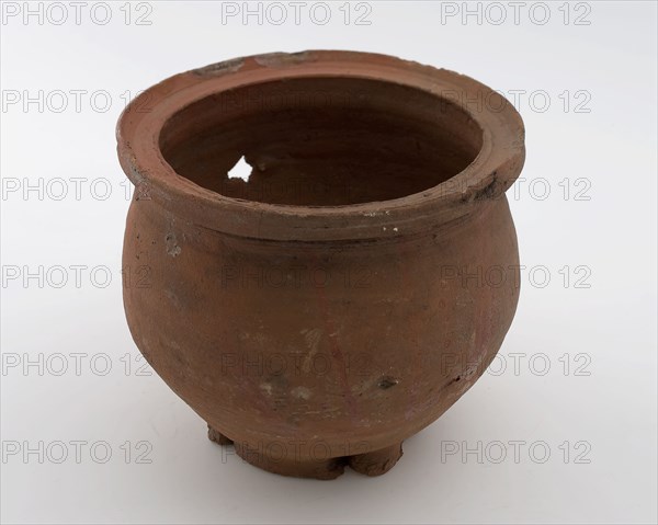 Earthenware flowerpot or colander, red shard, unglazed, five square holes in soil, on stand surface, flower pot holder earth