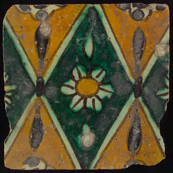 Floor tile, brown draft, green and yellow on white ground, central green oblique glass in which white flower with yellow heart