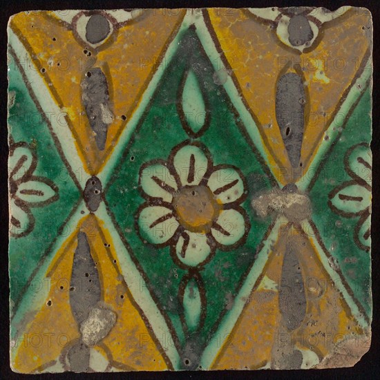 Floor tile, brown draft, green and yellow on white ground, central green oblique glass in which white flower with yellow heart