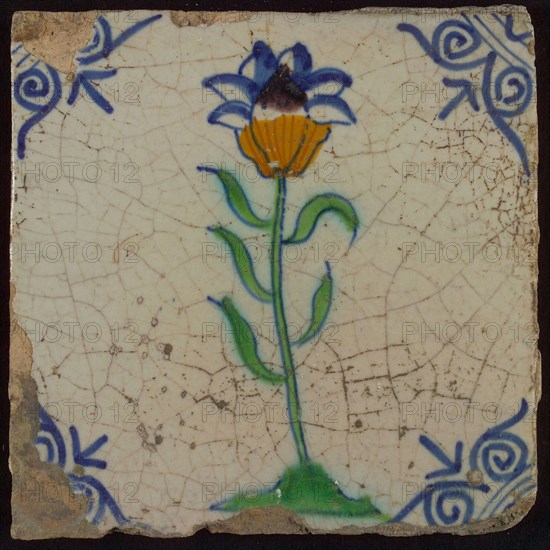 Tile, flower on ground in orange, purple, green and blue on white, corner motif oxen head, wall tile tile sculpture ceramic