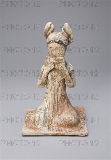Female Musician, Tang dynasty (A.D. 618–907), late 7th/early 8th century, China, Earthenware with polychrome pigments, 20.6 × 13.1 × 13.2 cm (8 1/8 × 5 3/16 × 5 3/16 in.)