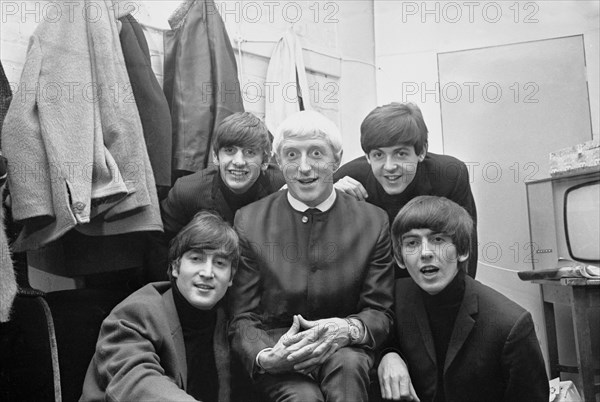 Disc Jockey Jimmy Saville pictured with Liverpool pop group The Beatles at Finsbury Park Astoria in London.
The Beatles and Saville appeared together on the first ever Top Of The Pops programme on New Year's Day, 1964.
Beatles are left to right, back row: drummer Ringo Starr and bass guitarist Paul McCartney.
Front: John Lennon and George Harrison.
11th January 1964.