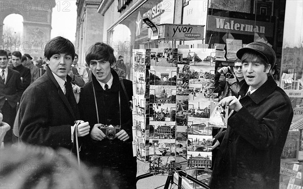 Paul MCCartney (left), George Harrison and John Lennon on the Champs Elysees before Ringo arrived in Paris later in the  day. 15 January 1964