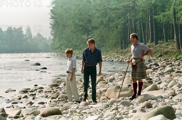 Prince Charles with sons Prince William and Prince Harry. Pictured on the banks of the River Dee at an official photocall at Balmoral, Scotland. 12th August 1997.