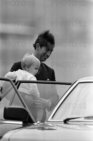 The Royal Family arrive for their summer holiday at Balmoral, Scotland. Prince Charles, Prince of Wales carries Prince William at Aberdeen Airport. 15th August 1983.