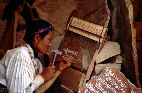 A woman carving scripture on the stone, Lhasa