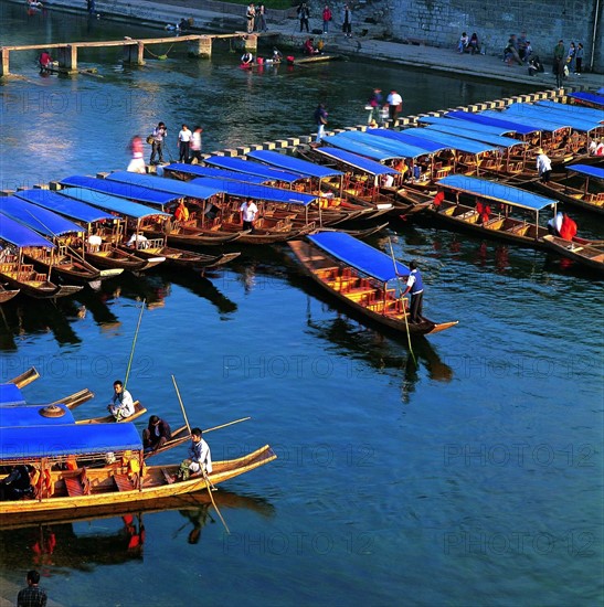 the boats by the river at the north gate of Ancient Phoenix City,Hunan Province,China
