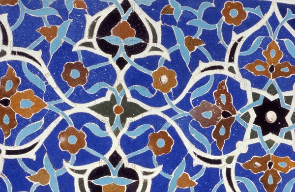 Glazed tiles adorning the brickwork of a a Persian mosque in Isfahan