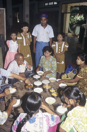 Buddhist family lunch in a temple in Myanmar