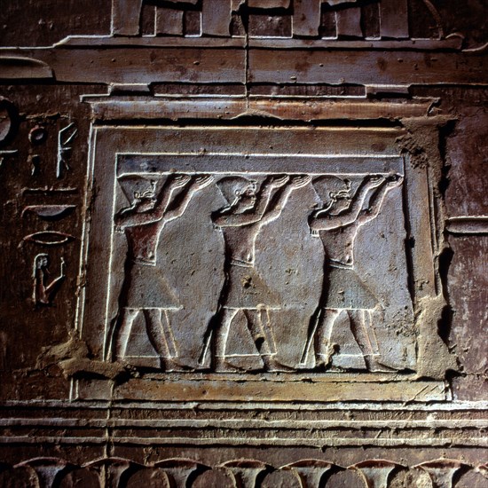 Deir el-Medina, Ptolemaic temple, left-hand chapel - the barque of Sokaris, detail of its altar of repose, the raising of the sky by Pharaoh